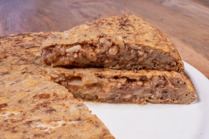 Tortilla rellena de morcilla sobre plato blanco